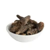 A close-up of high-quality dried morel mushrooms in a white bowl.